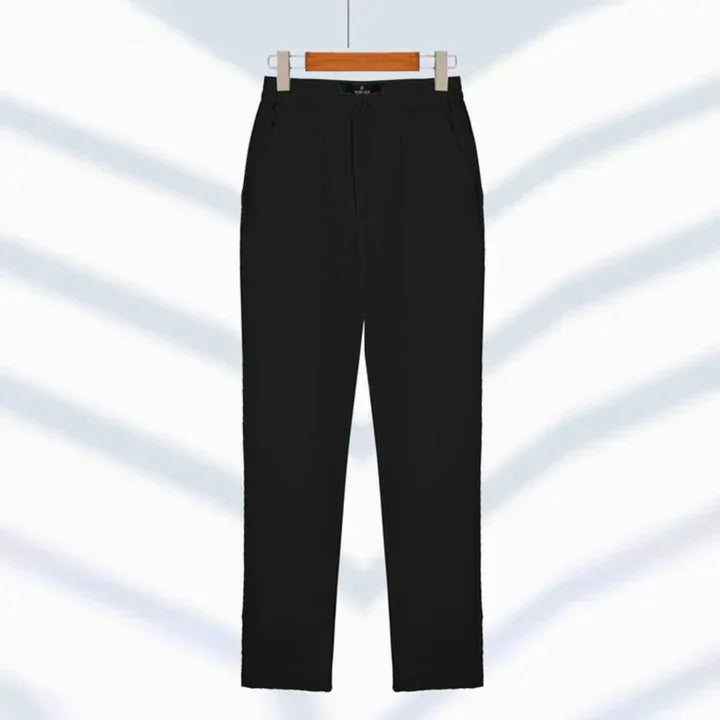 Classic black tailored suit pants hanging on wooden hanger, Rovelli fashion