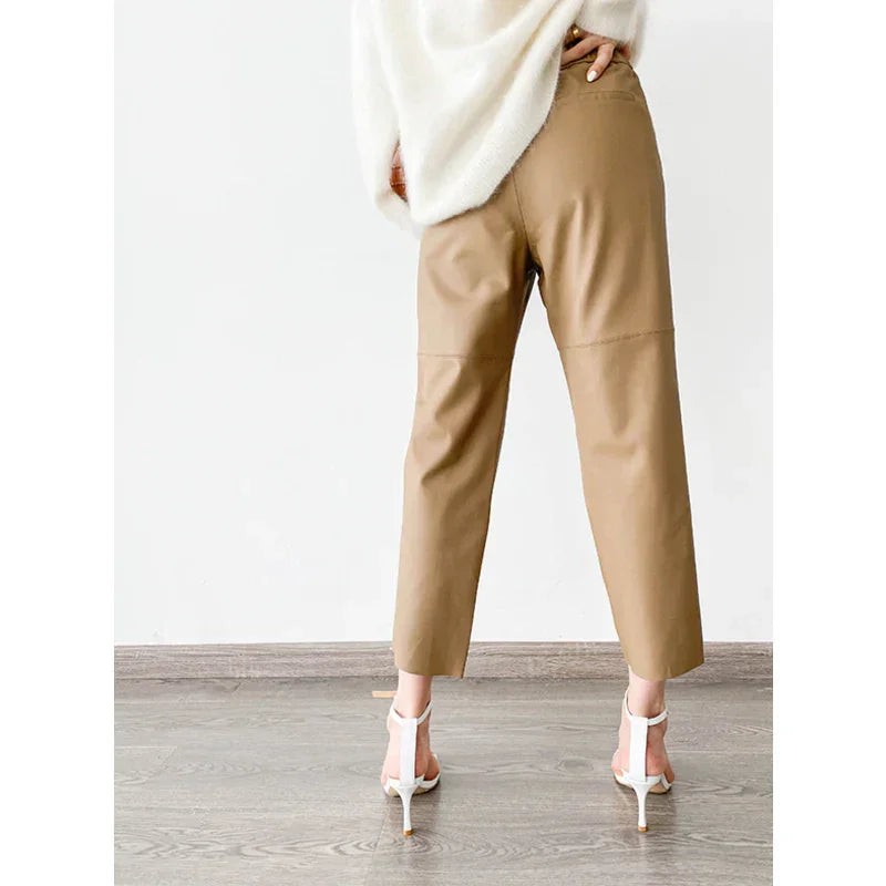 Beige leather pants for women by Rovelli, shown from back, styled with white heels.