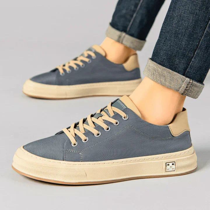 Rovelli grey and beige Ariston sneakers with tan laces, worn with rolled-up jeans