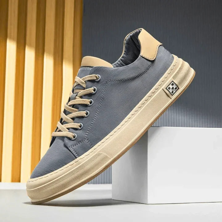 Rovelli Ariston sneaker in gray with beige sole and laces, modern minimalist background