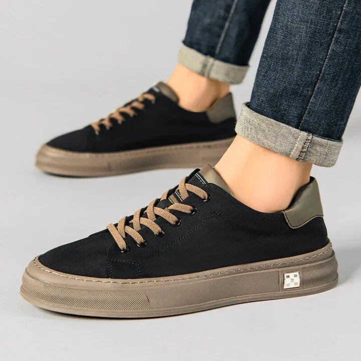 Rovelli black and brown casual sneakers on model with rolled-up jeans, side view