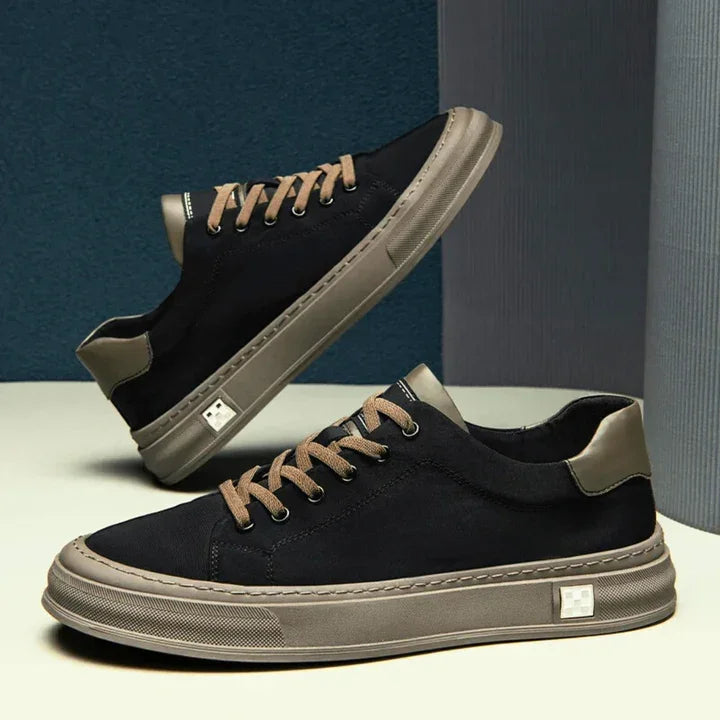 Rovelli black and taupe Ariston sneakers with tan laces on modern studio background