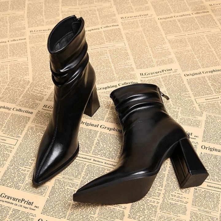 Black leather heeled ankle boots on vintage newspaper background, Rovelli fashion footwear