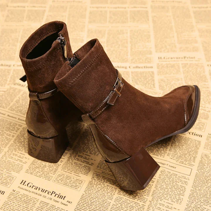 Brown suede ankle boots with block heels and buckle detail on newspaper, Rovelli footwear
