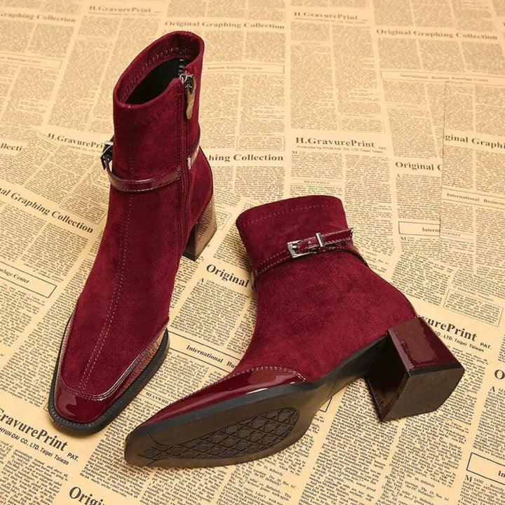Rovelli burgundy suede ankle boots with side zippers and buckles on vintage paper background