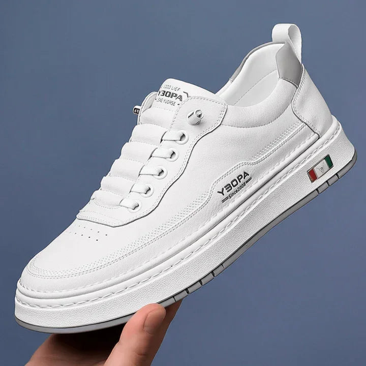 Rovelli white leather sneaker with side logo and Italian flag detail, held by hand