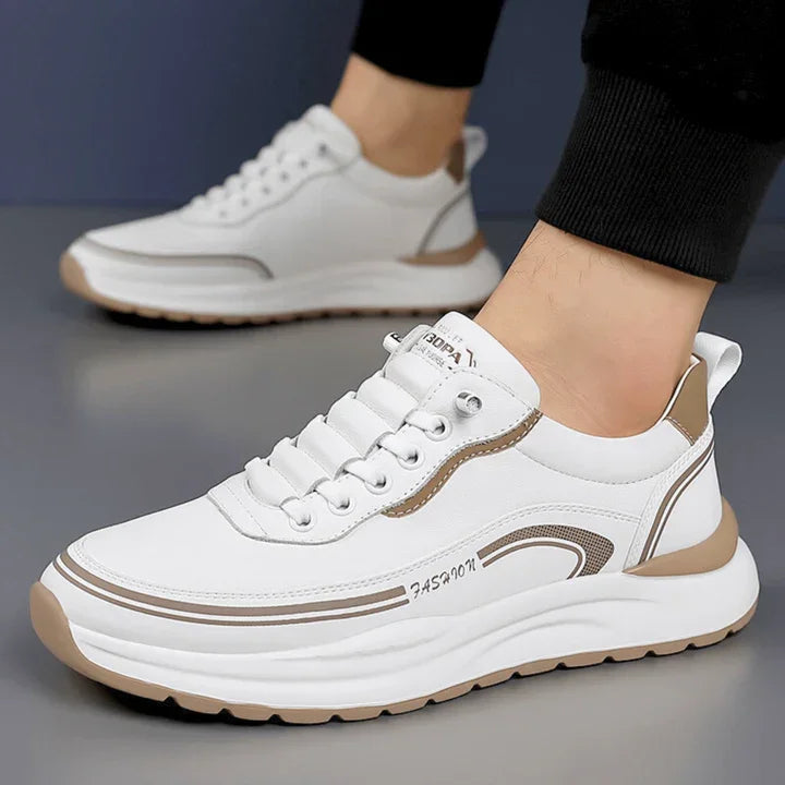 White and tan Rovelli men's sneakers with lace-up design and chunky sole on grey floor