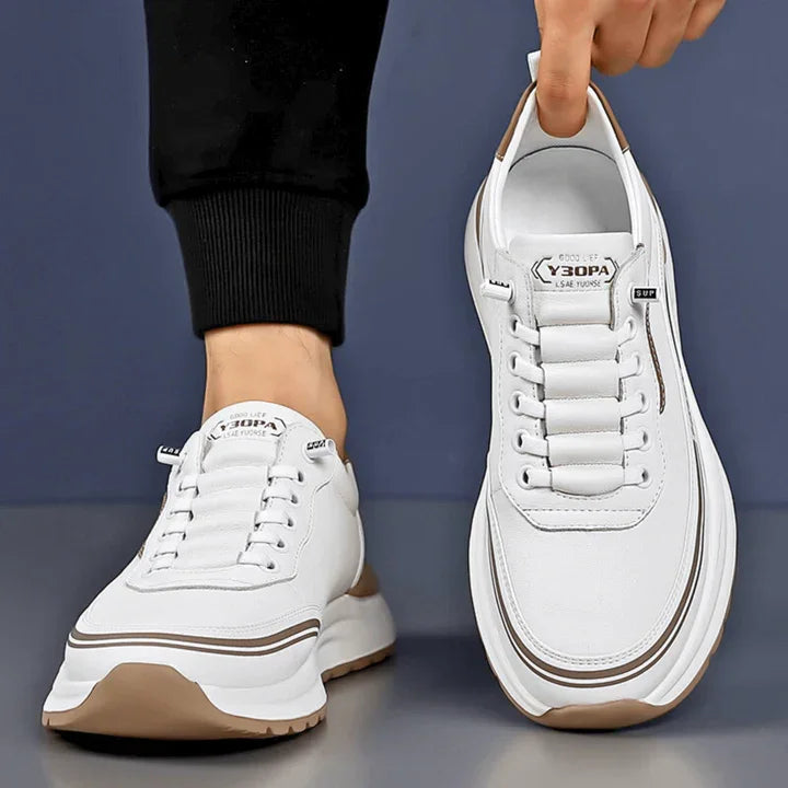 Rovelli white leather sneaker with beige sole held and worn on blue background