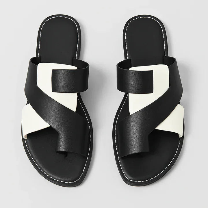 Black and white cross-strap slides with stitched soles, Rovelli sandals top view