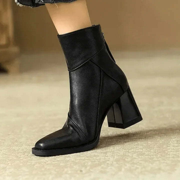 Rovelli black leather ankle boot with block heel on beige carpet