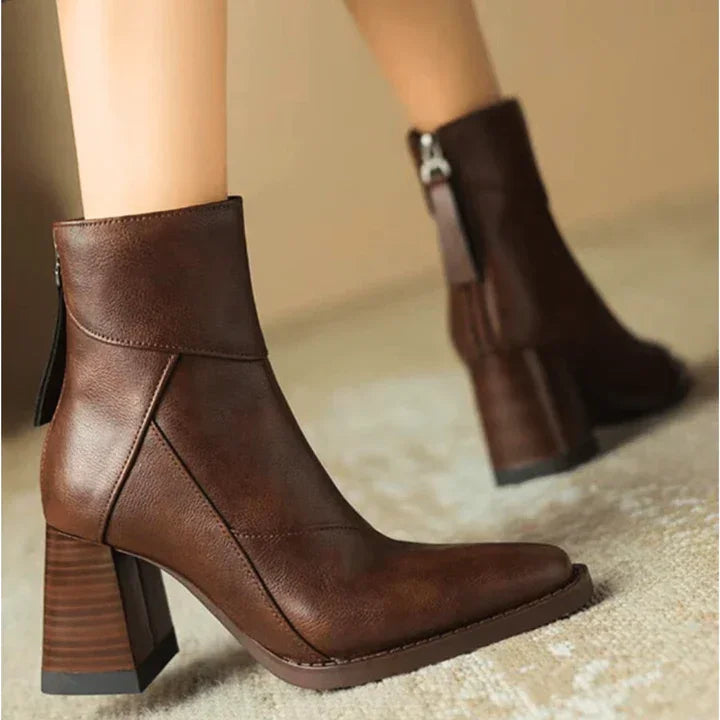 Rovelli brown leather ankle boots with block heels on a neutral carpet
